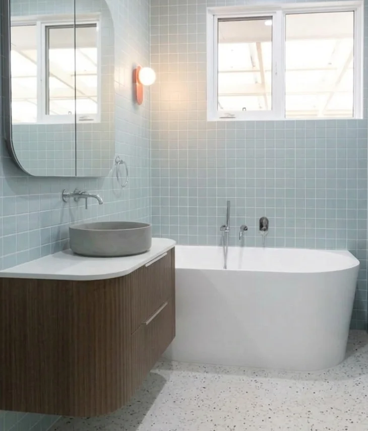 Bathroom after renovation — blue tile, walnut vanity, terrazzo floor, Redmond WA