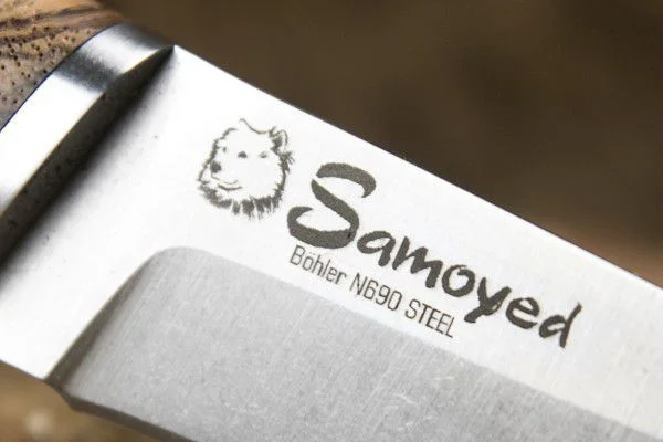 Close view of the crisp StoneWash finish and N690 marking on a Kizlyar Supreme Samoyed blade
