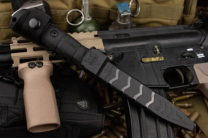 Black Vector sheath and mounting system beside tactical equipment