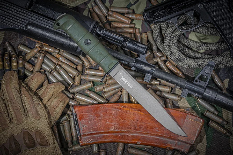 Olive Vector knife displayed among field equipment