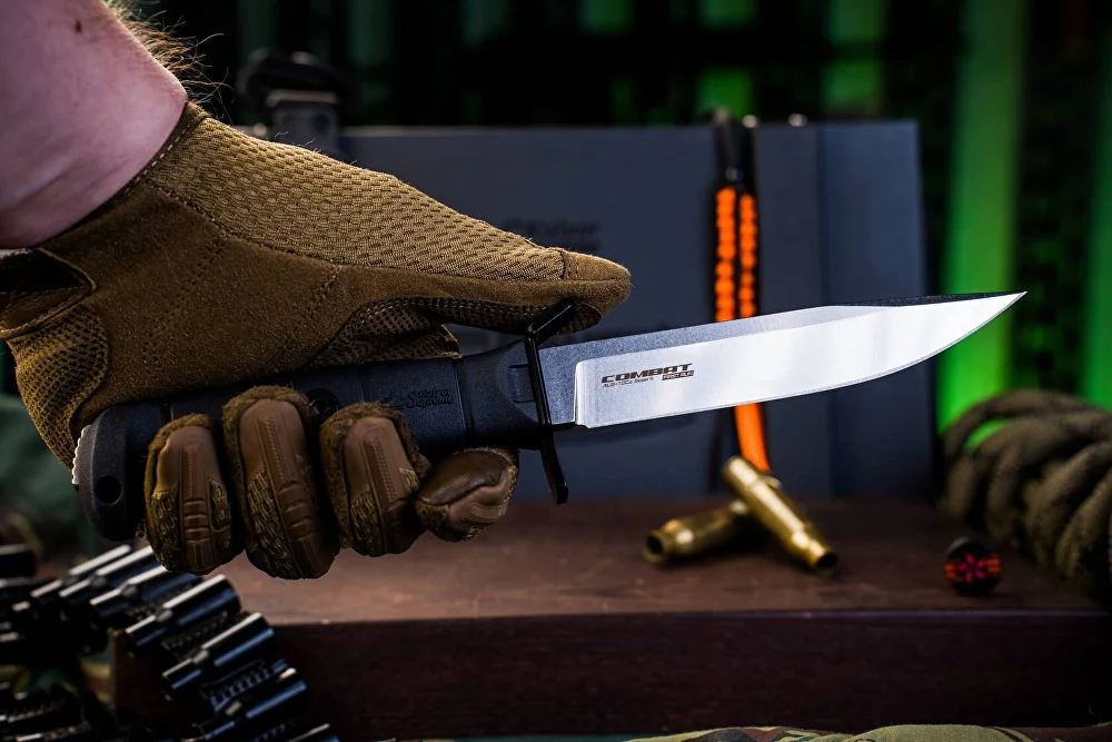 Black Combat knife showing the full-tang handle and exposed pommel