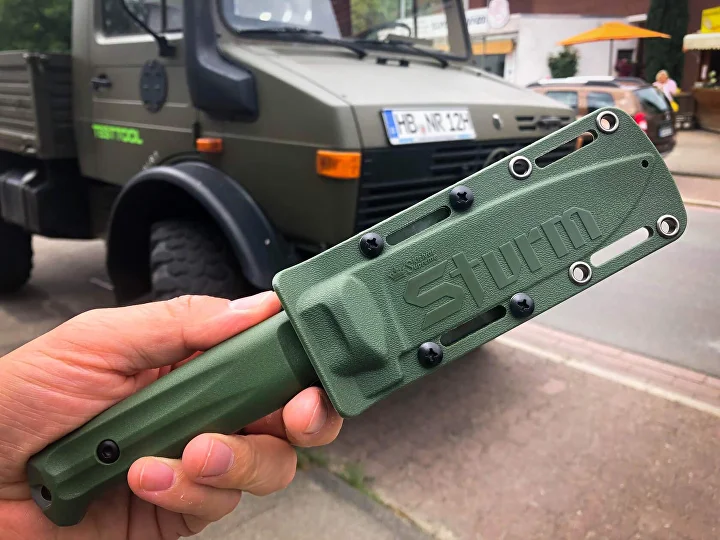 Olive Sturm locking sheath held in hand