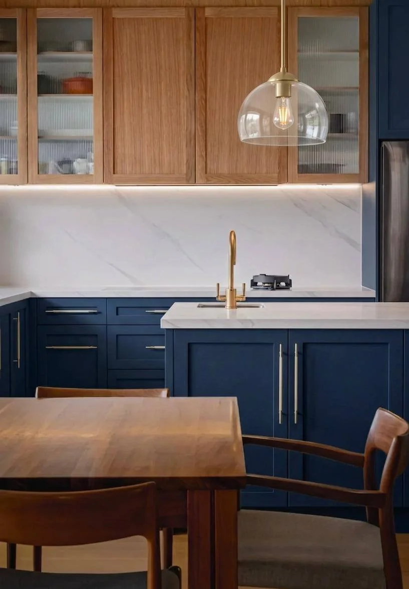 Induction cooktop with wok burner, marble countertop and backsplash, navy blue cabinets — Woodinville WA kitchen