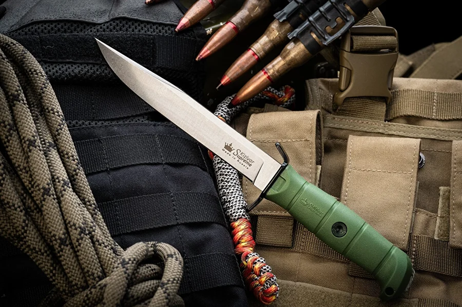 Olive Vector knife laid across field gear