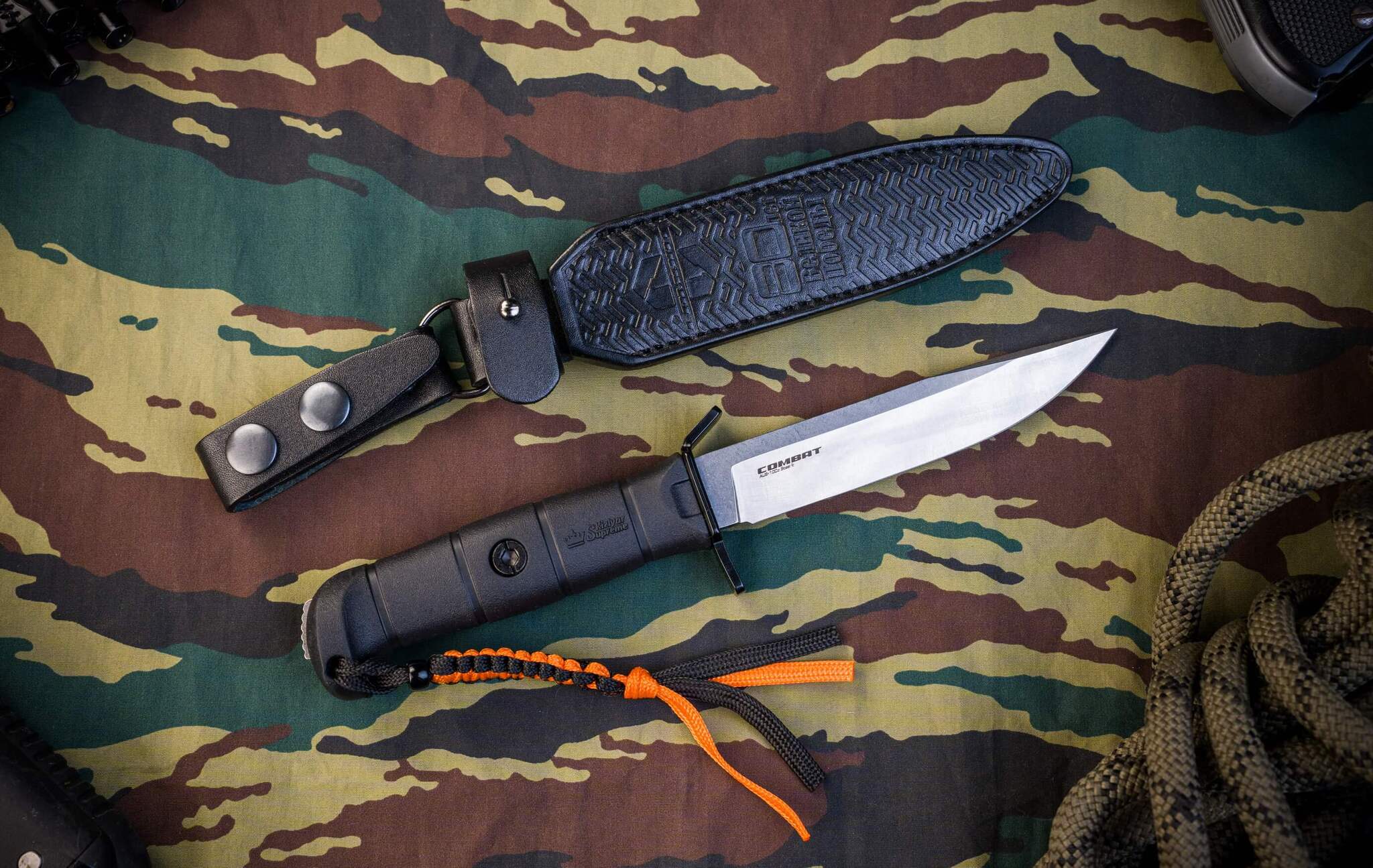 Olive Combat fixed blade displayed outdoors