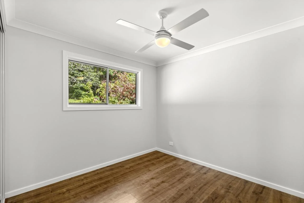 Rental DADU bedroom Bothell — ceiling fan LVP flooring built-in closet garden view window