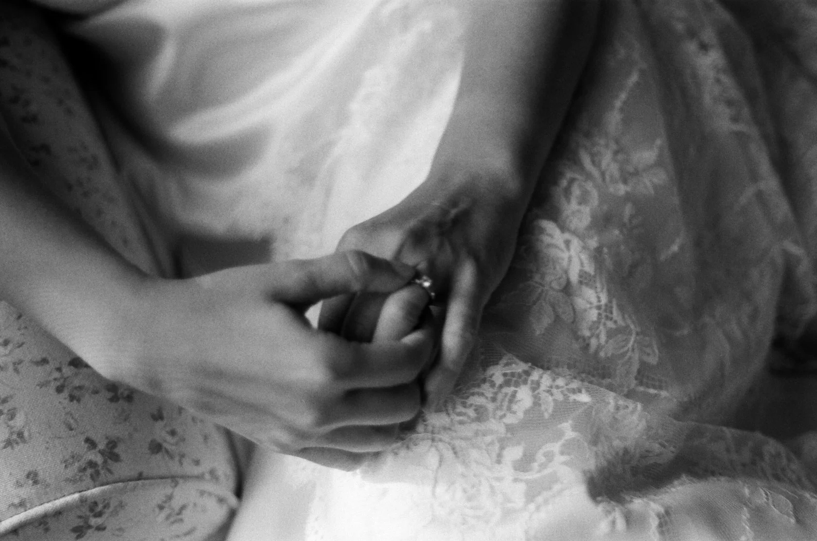 Black-and-white film photo of the couple holding hands