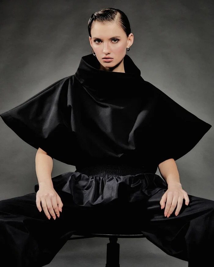 Fashion editorial model wearing a sculptural black silhouette