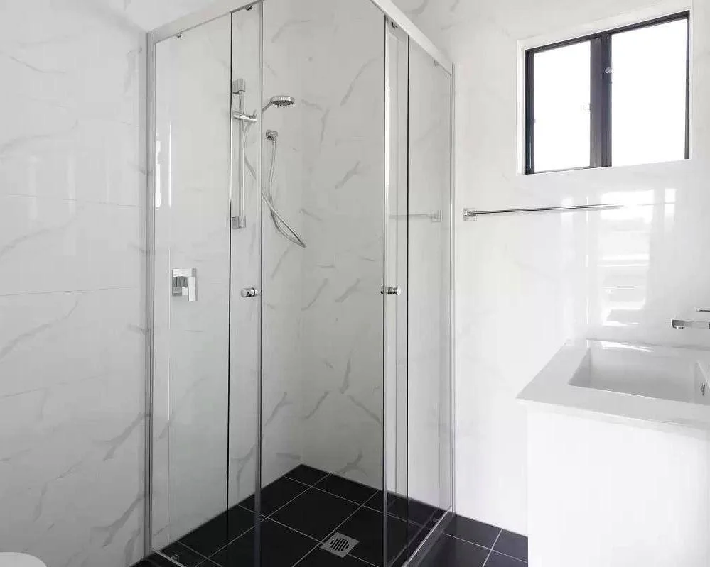 Modern DADU bathroom Edmonds — frameless glass shower marble tile wall-mounted vanity