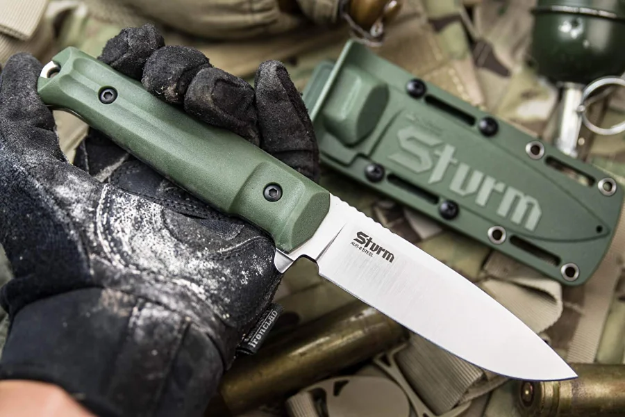 Olive Sturm knife and sheath on field equipment