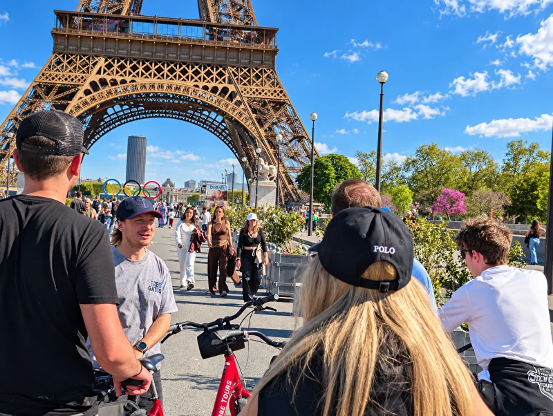 The guide with riders and their bikes outside the Hôtel de Ville
