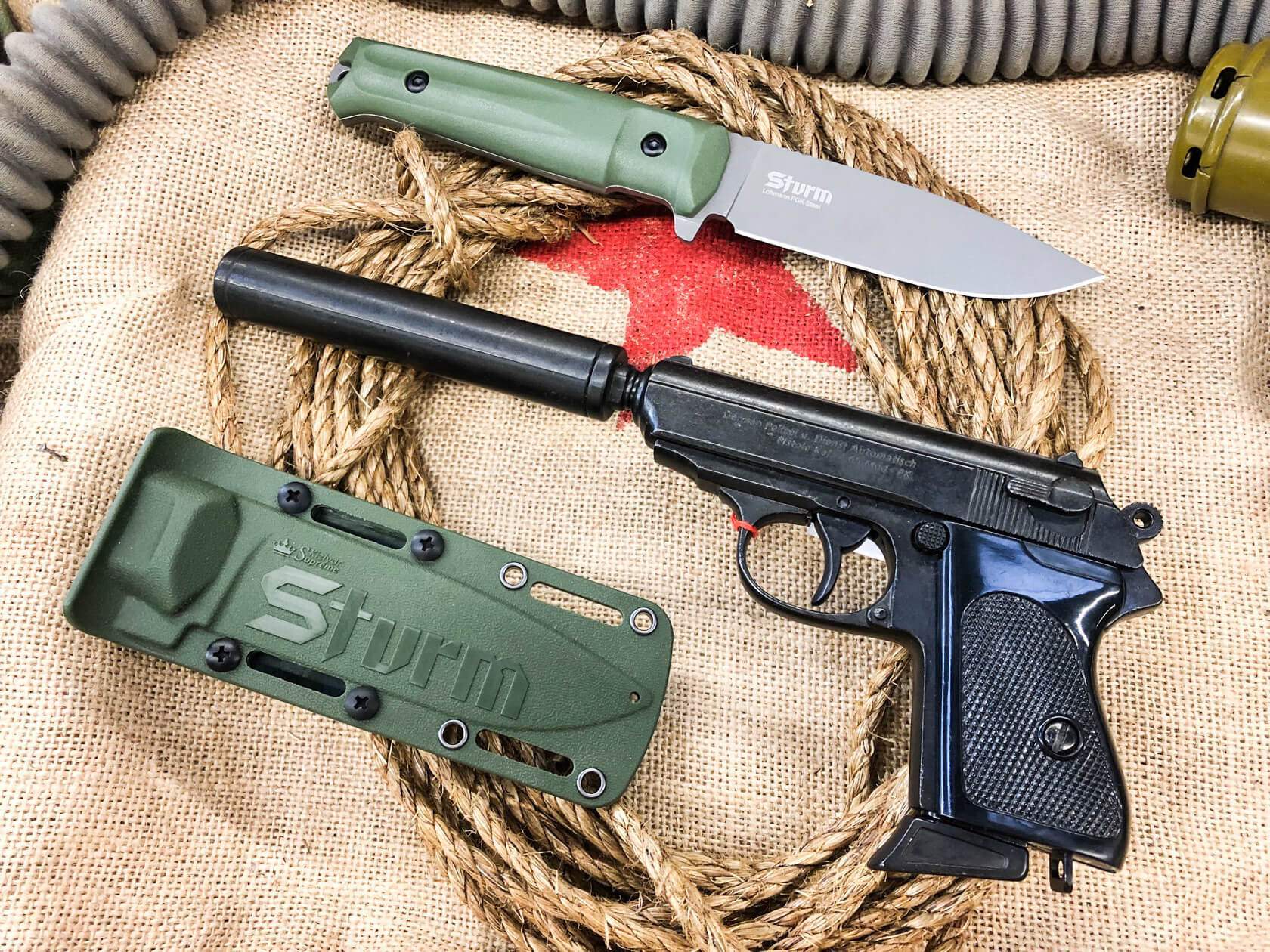 Olive Sturm knife, sheath and field equipment shown as a complete carry system