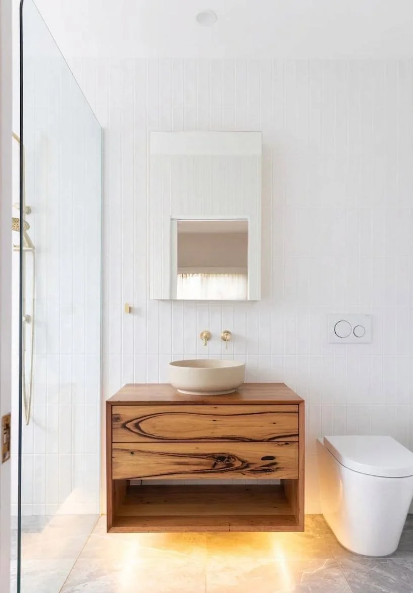 Brushed brass rain showerhead with handheld, built-in marble niche, and freestanding tub — bathroom remodeling Bellevue WA