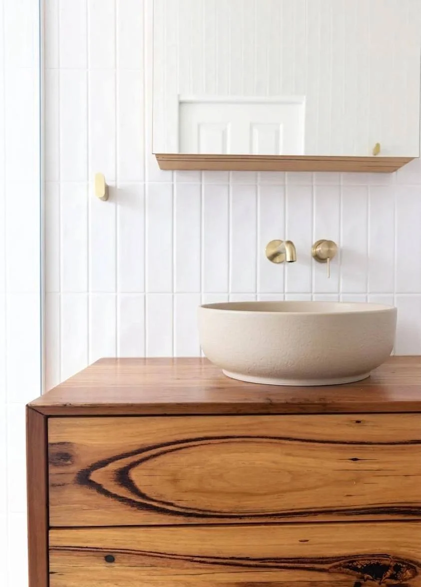 Floating recycled timber vanity with ceramic vessel basin, brushed brass faucet, and mirror cabinet — Bellevue WA