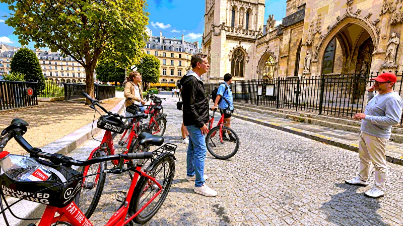 The guide talking to the group beside a Gothic church in central Paris