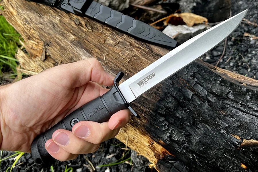 Vector fixed-blade knife held securely in hand outdoors
