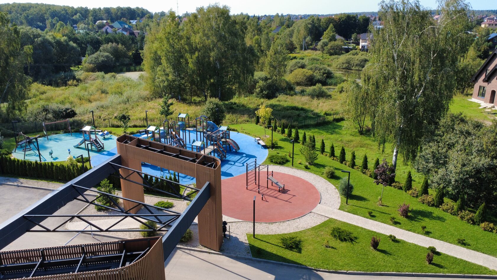Drone view of modern cottage settlement near forest
