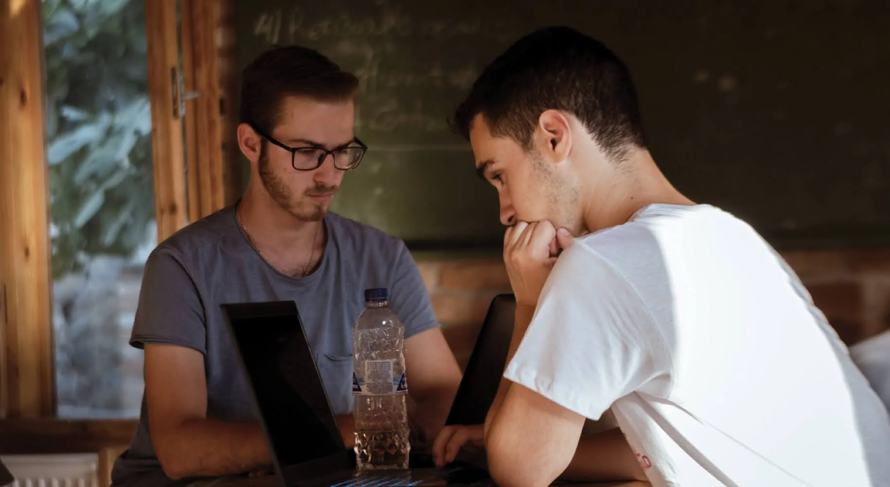 Two students working on their essays