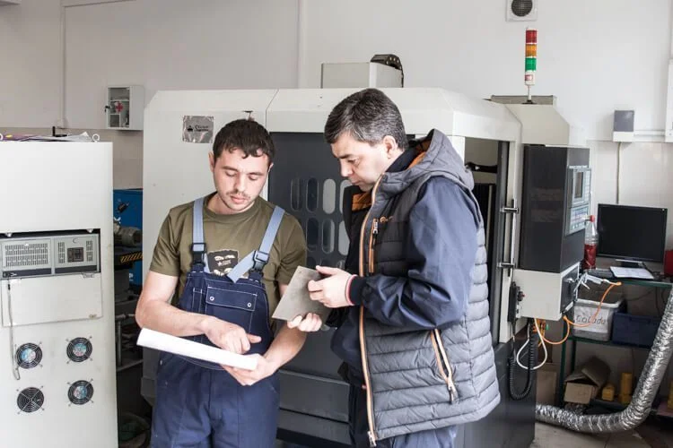 Kizlyar Supreme specialists reviewing a blade during production