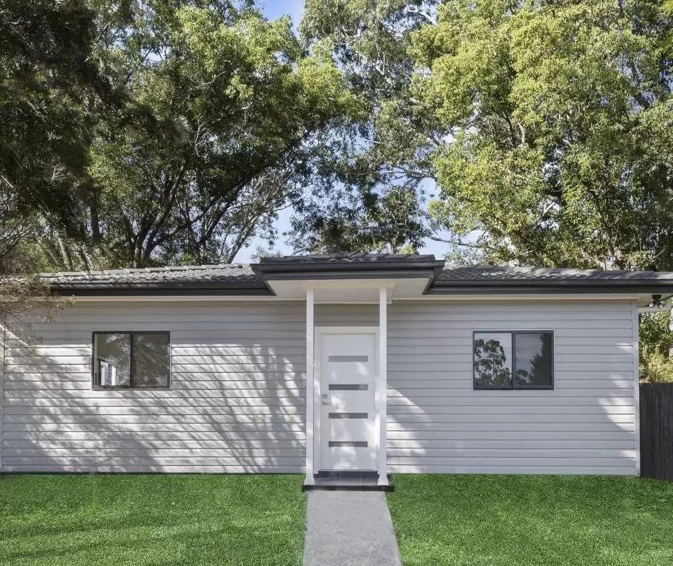 750 sq ft modern DADU exterior front view Edmonds WA — white fiber cement siding black window frames