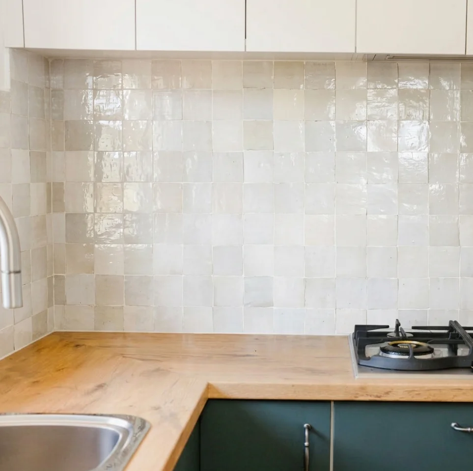 Butcher block oak countertop with gas cooktop, turquoise tile backsplash, and teal cabinets — Edmonds WA kitchen
